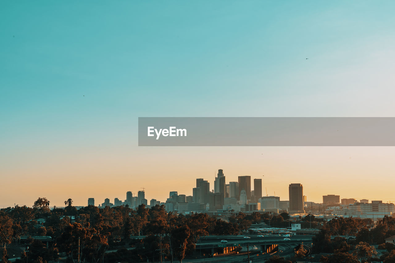 PANORAMIC VIEW OF BUILDINGS IN CITY AGAINST CLEAR SKY