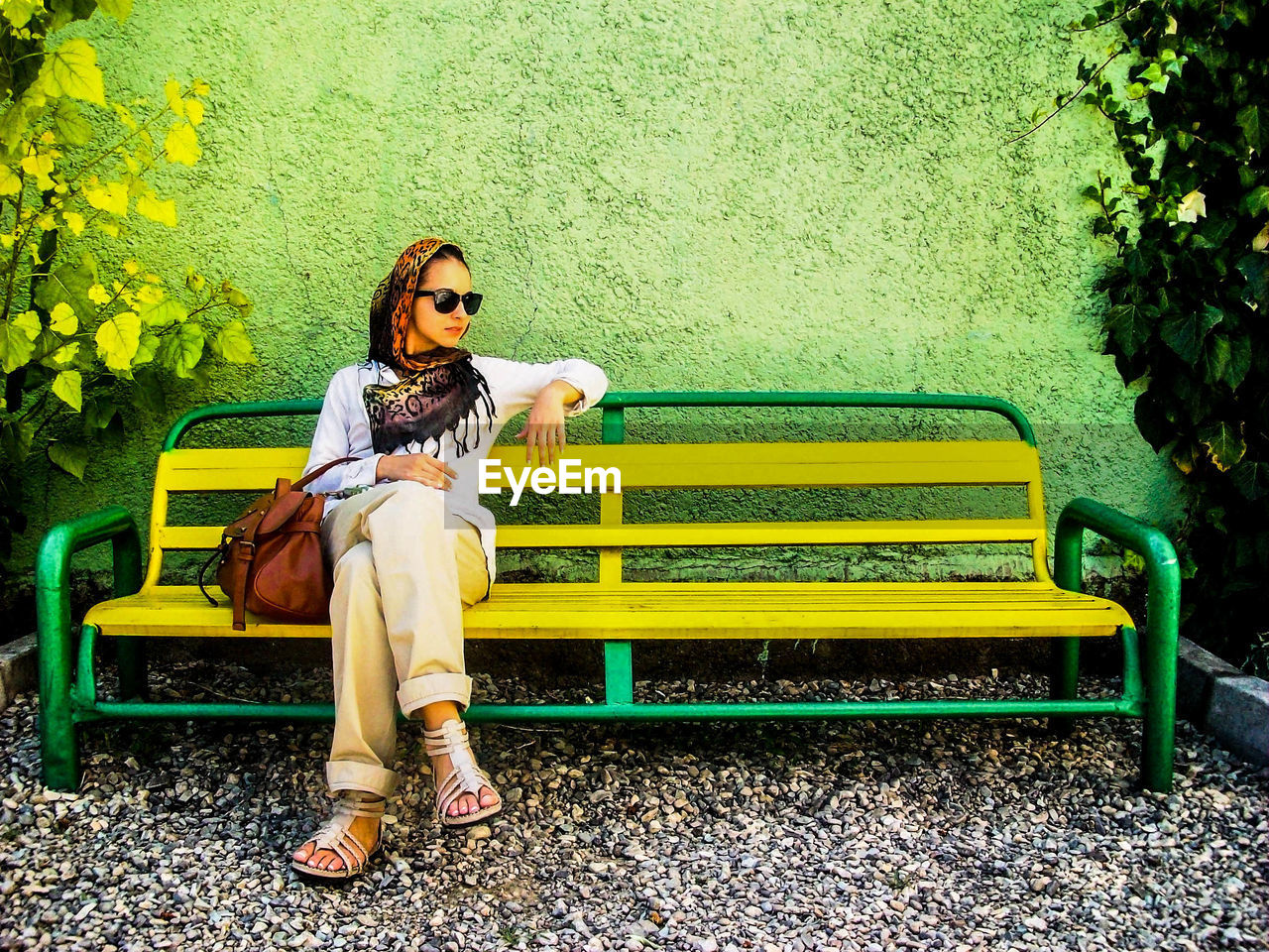 Full length of woman sitting on bench