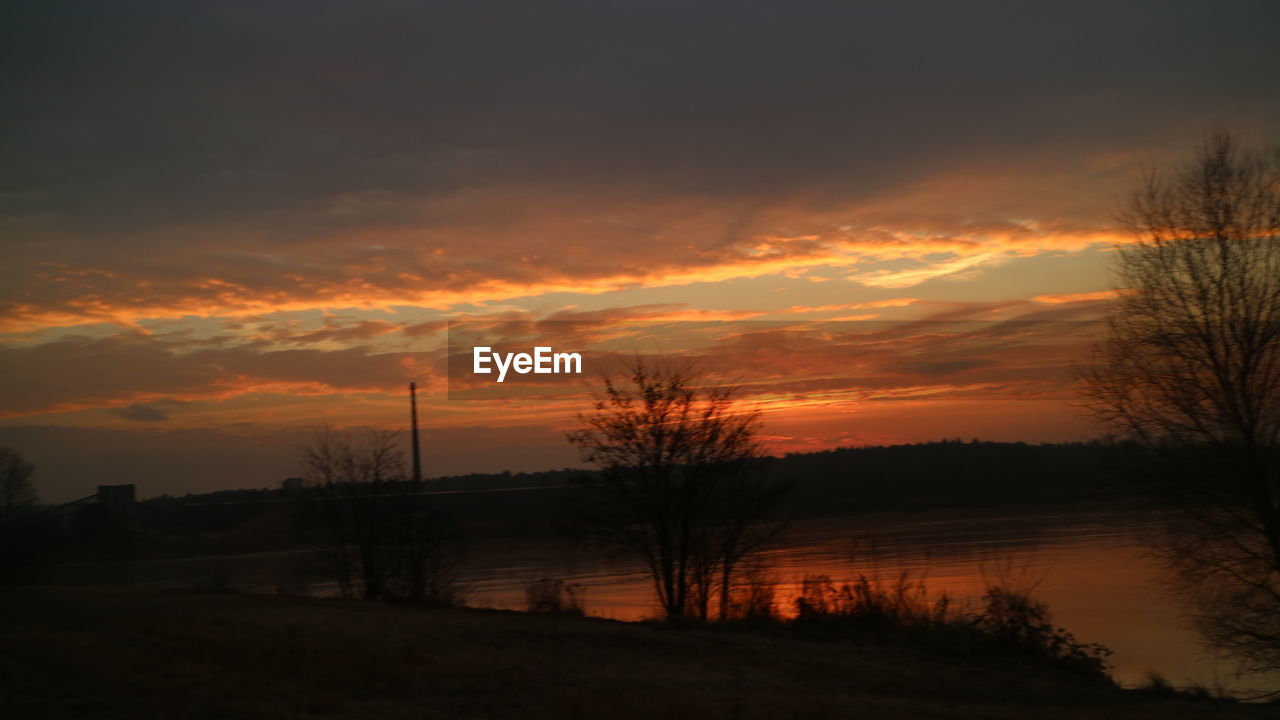 SCENIC VIEW OF SILHOUETTE TREES AGAINST DRAMATIC SKY