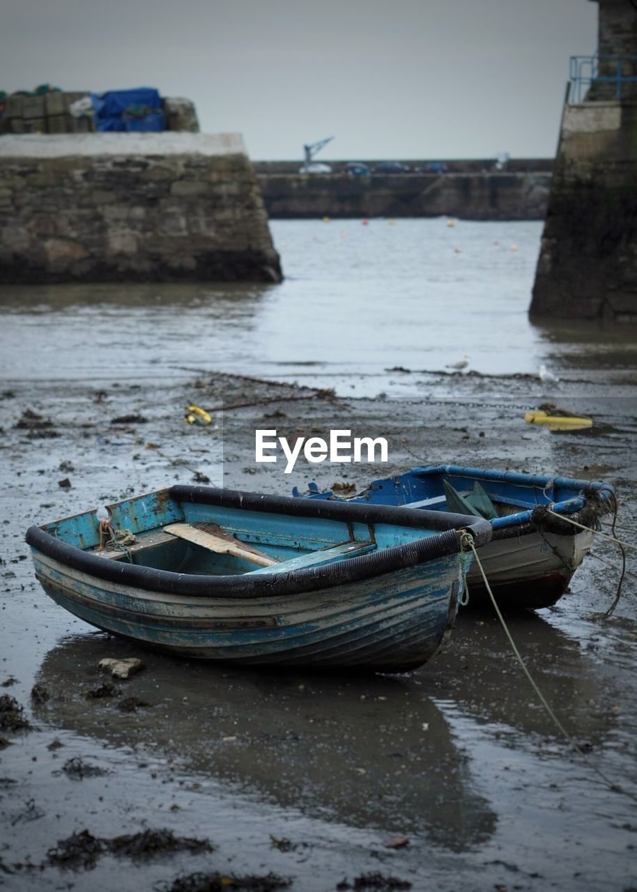 Old boat moored at sea shore