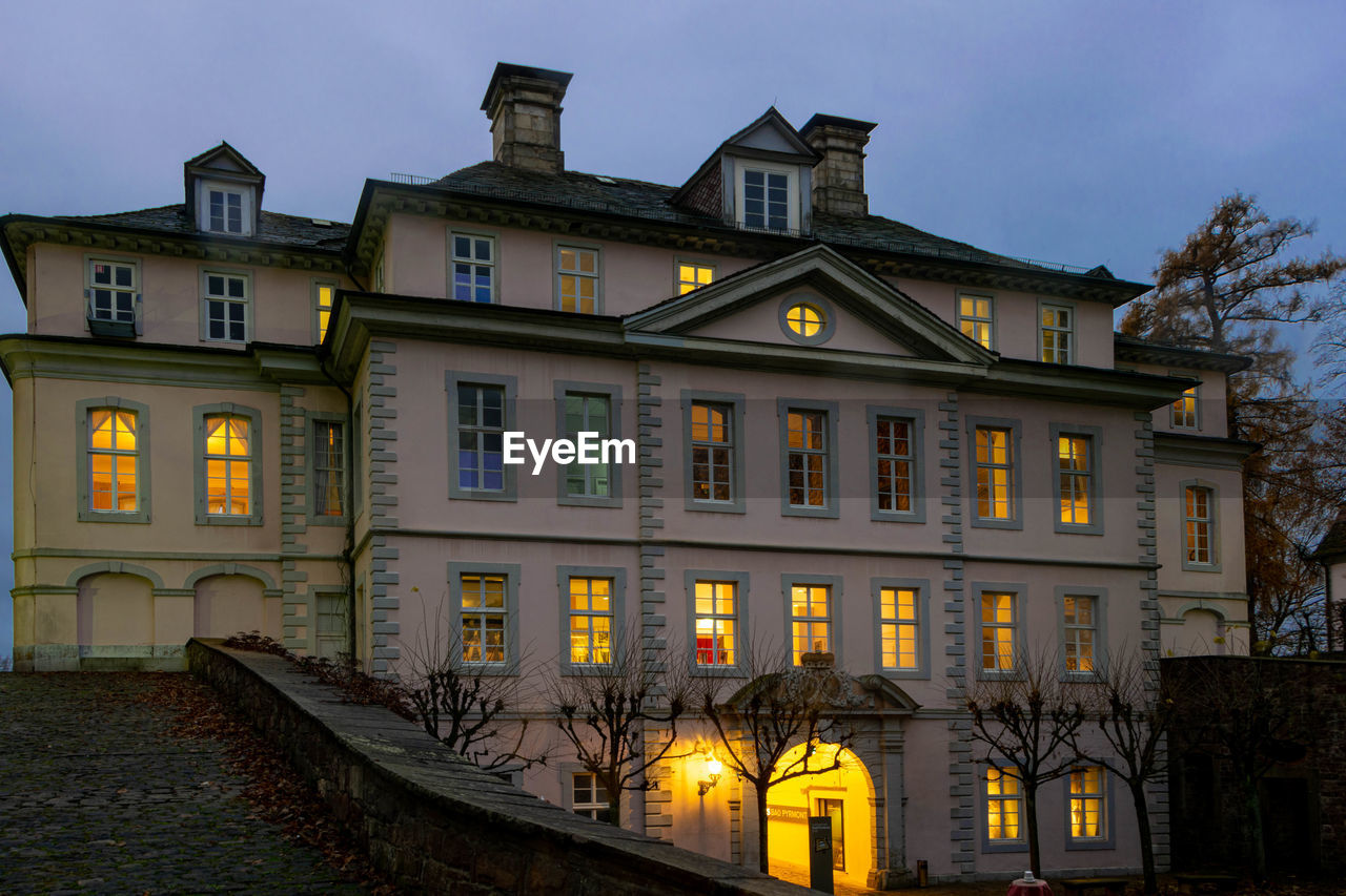 Exterior of old building against sky at dusk