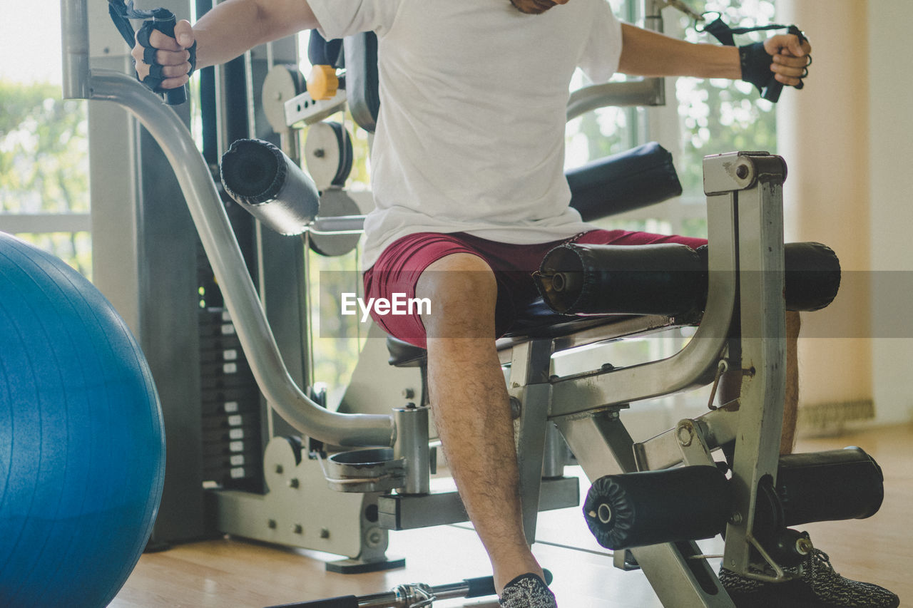 Low section of man exercising in gym