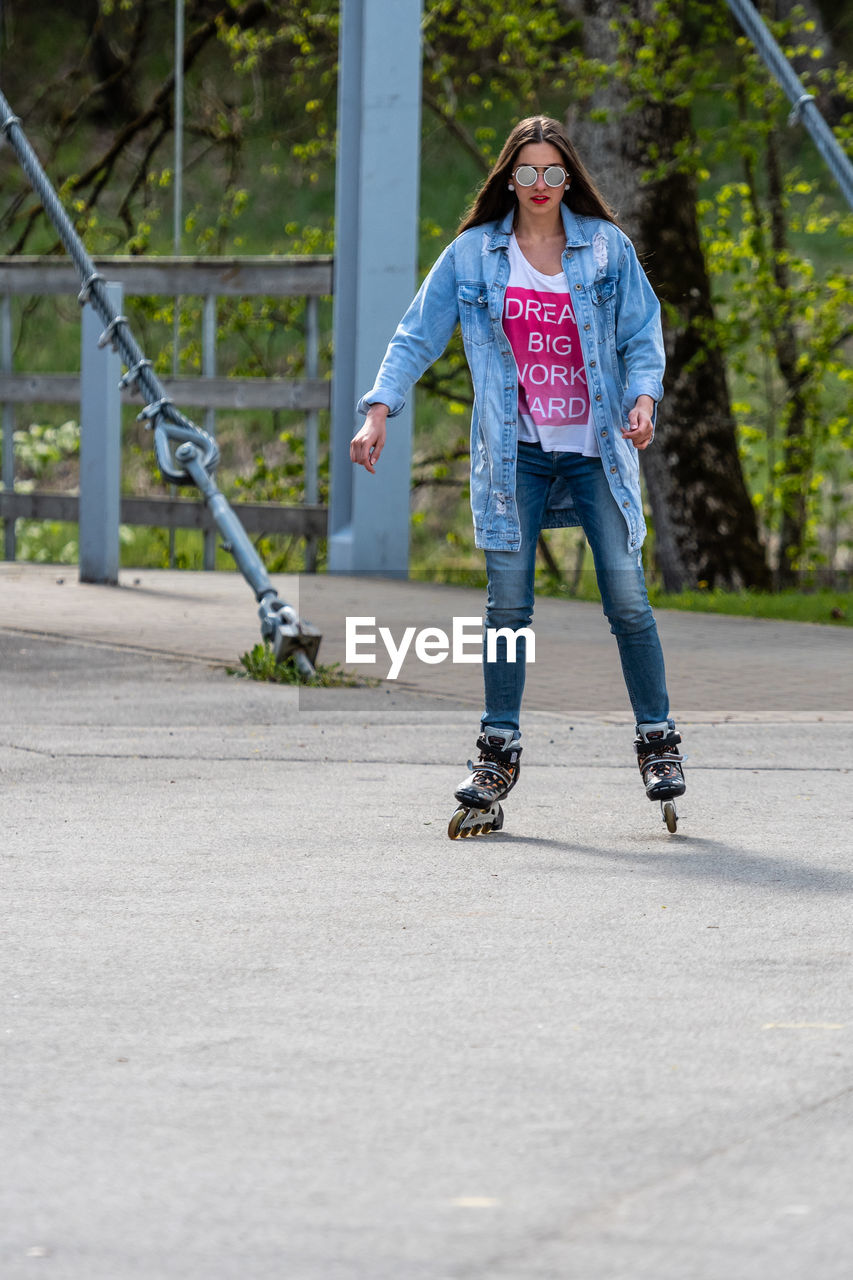 FULL LENGTH OF BOY SKATEBOARDING ON SKATEBOARD