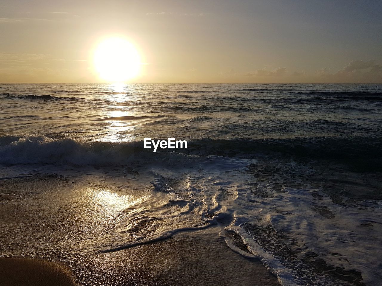 SCENIC VIEW OF BEACH DURING SUNSET