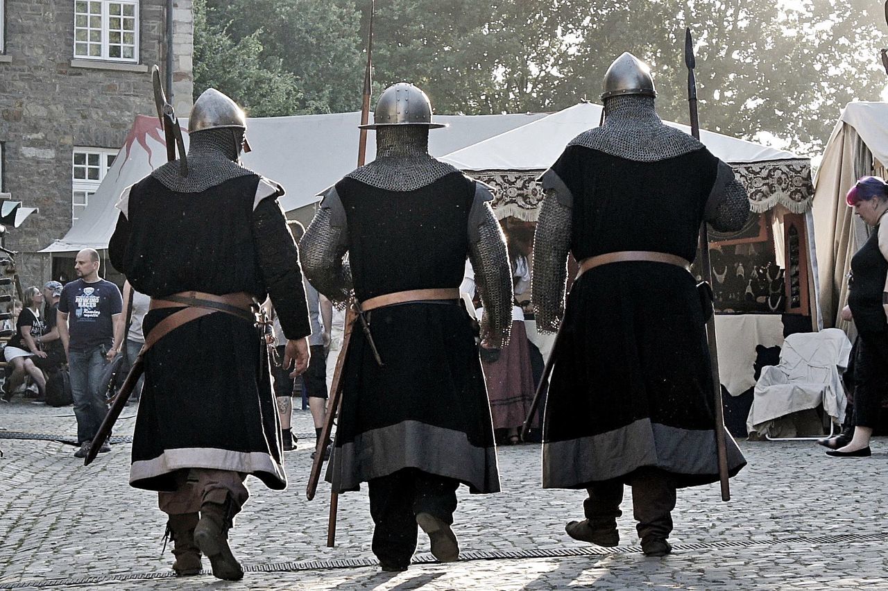 Rear view of men in medieval costume at hordel