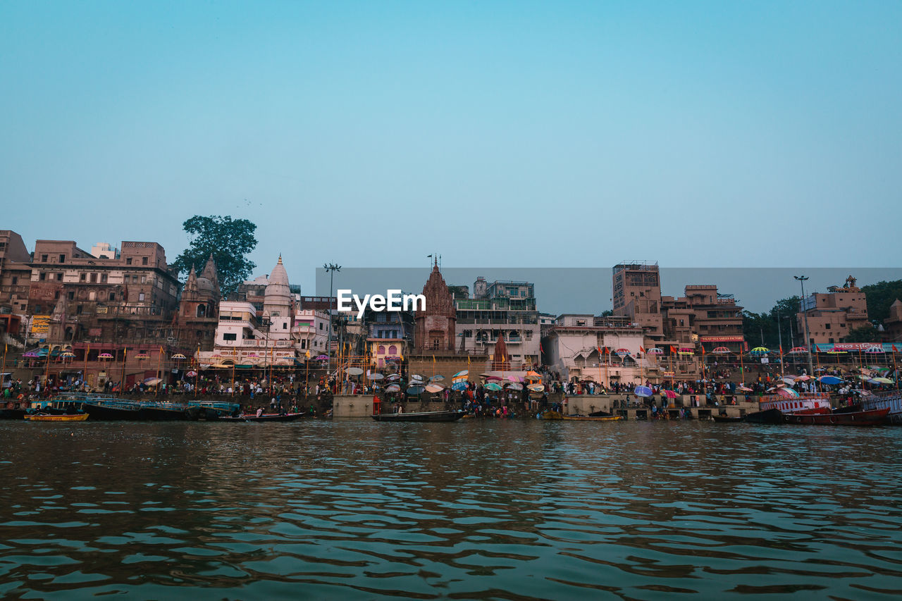 RIVER AND BUILDINGS AGAINST CLEAR SKY