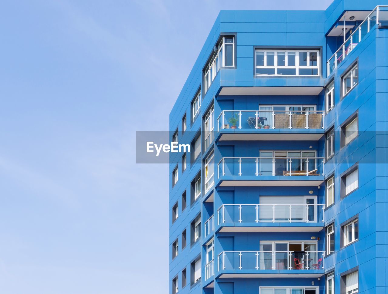 Low angle view of blue building against clear sky