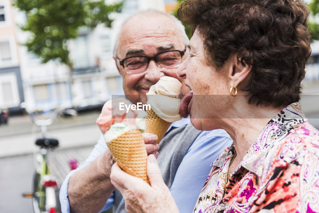 Senior couple enjoy eating ice cream together