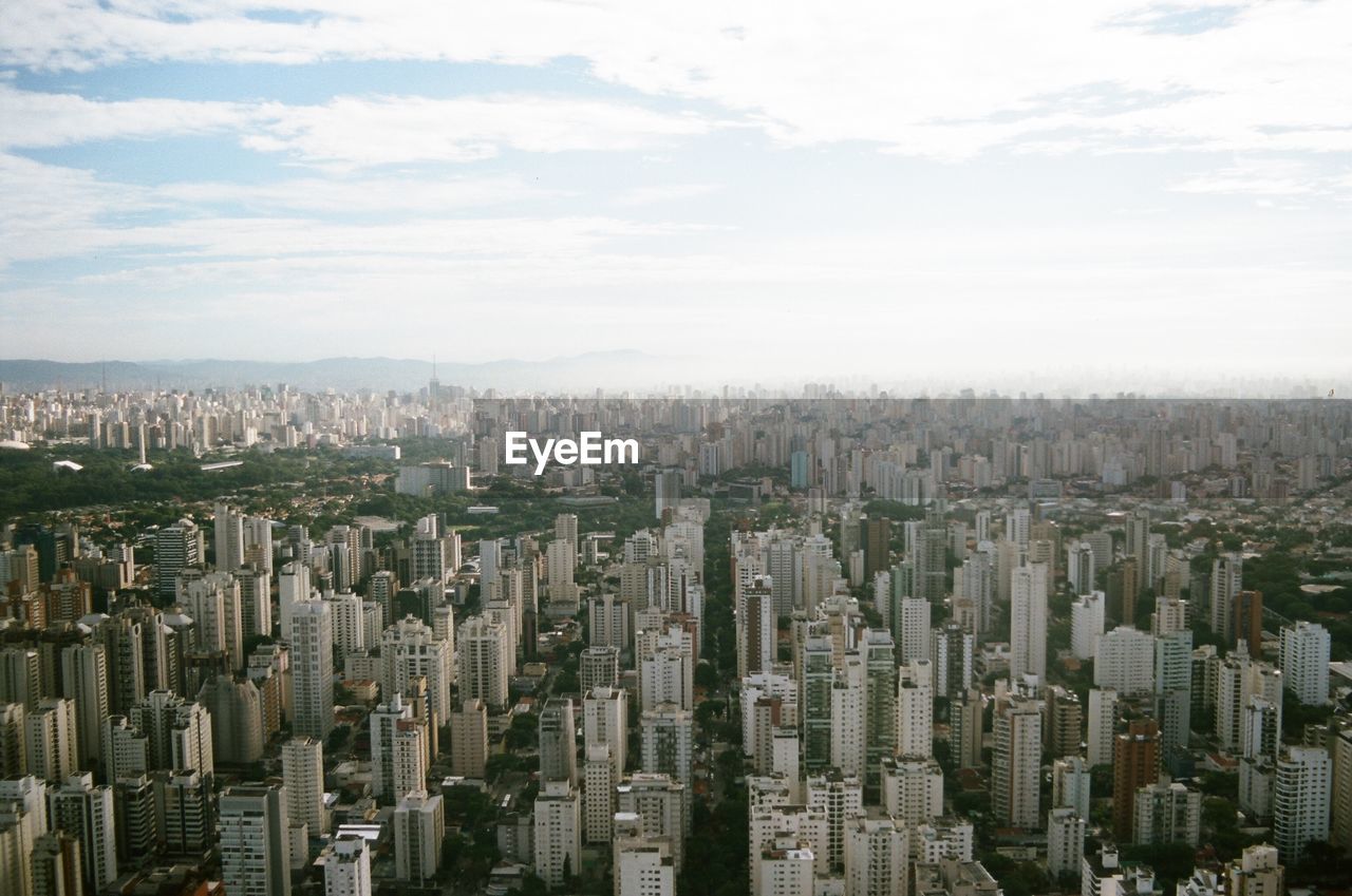 High angle view of modern buildings in city against sky