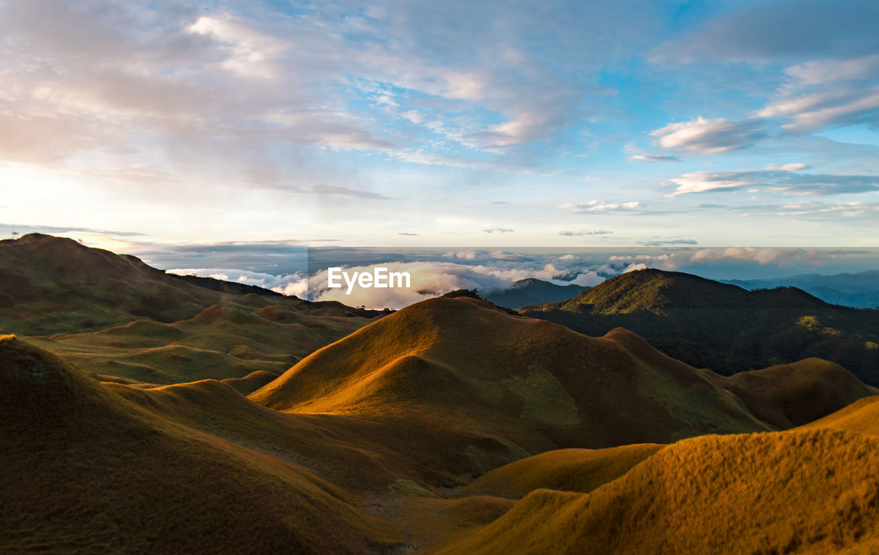 Scenic view of mountains against cloudy sky