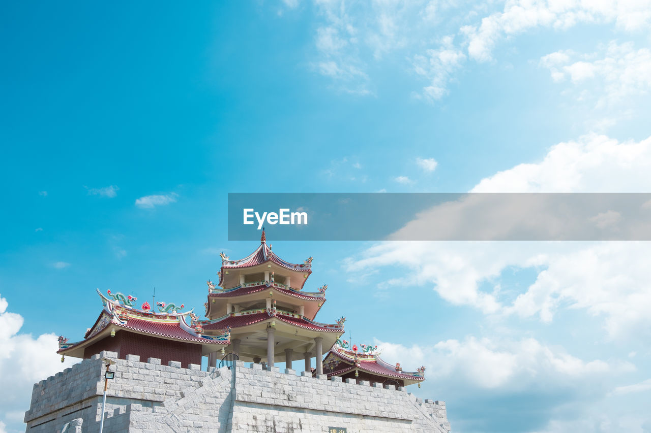 LOW ANGLE VIEW OF TEMPLE AGAINST BUILDING