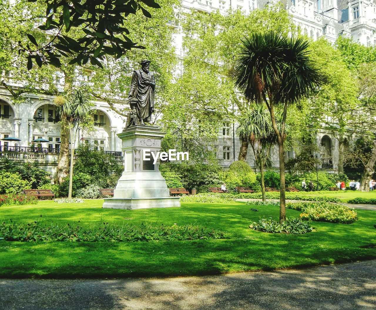 Low angle view of statue in park against building