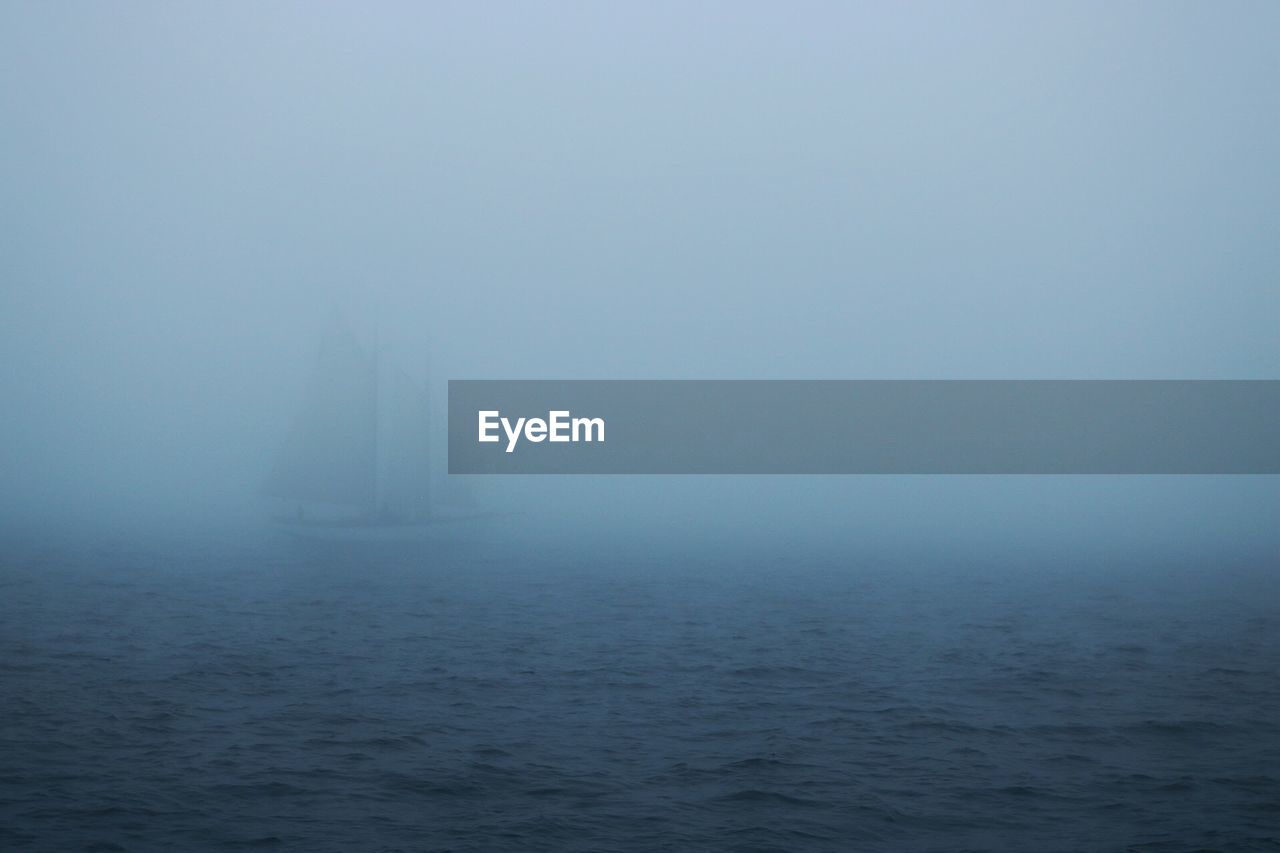 SCENIC VIEW OF SEA IN FOGGY WEATHER AGAINST SKY