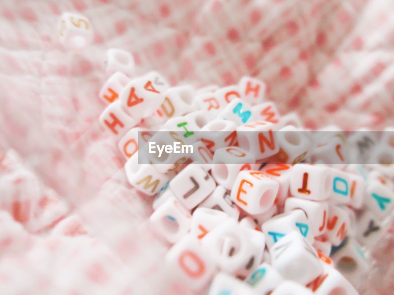 Close-up of toy blocks with colorful alphabets on fabric