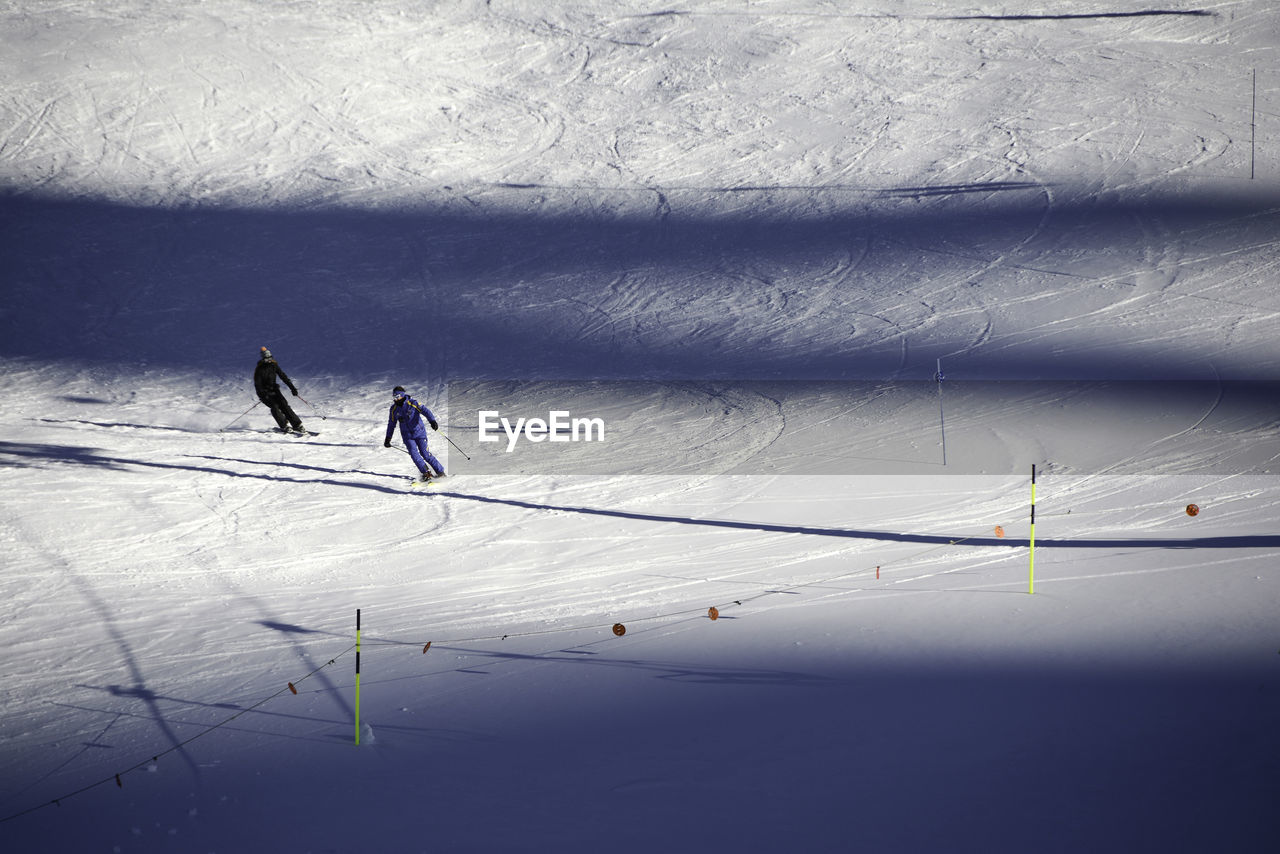 PEOPLE ON SNOW COVERED LANDSCAPE