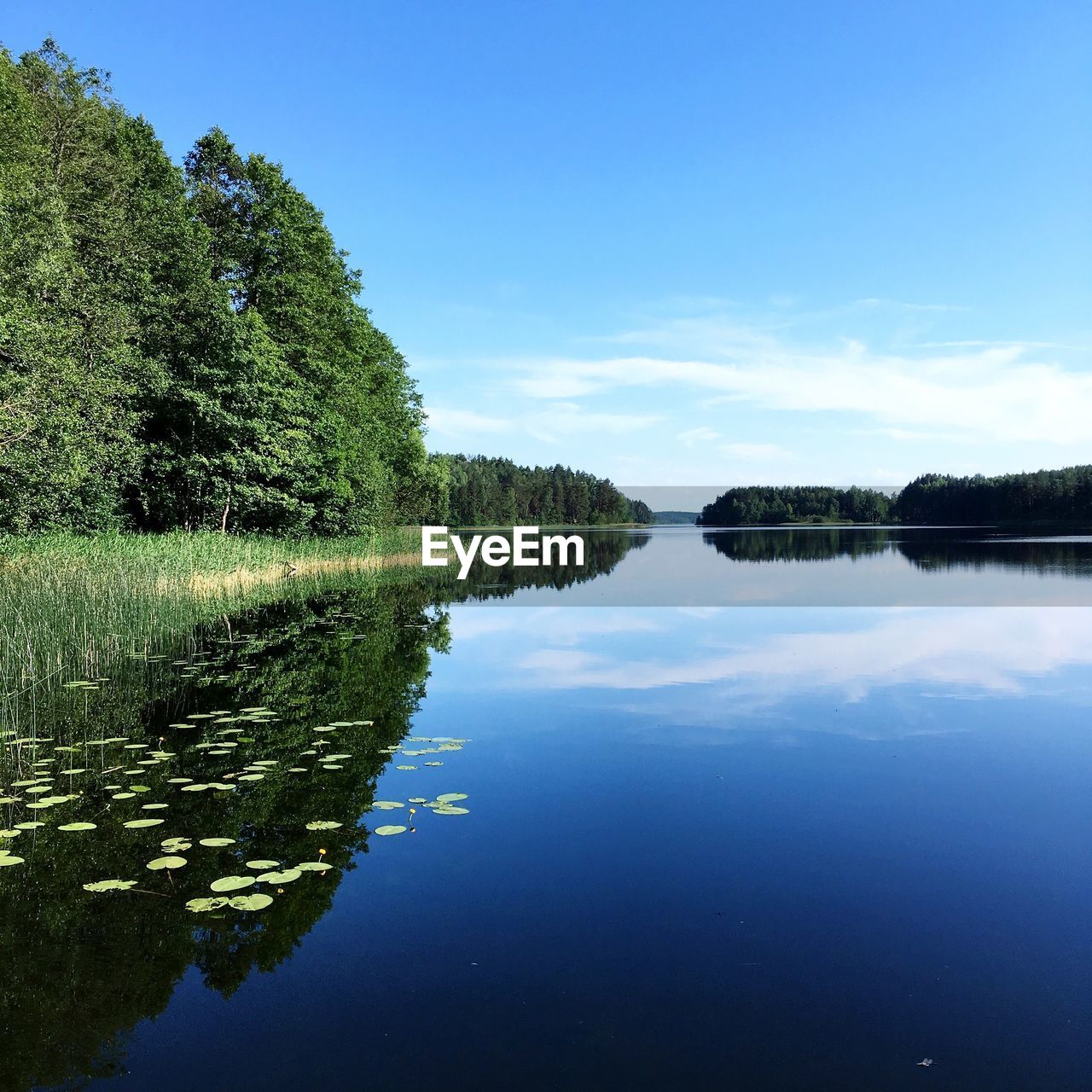 Scenic view of lake against blue sky