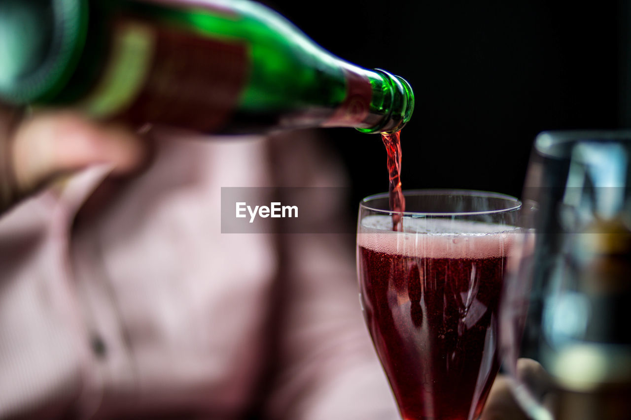 Close-up of wine being poured in glass