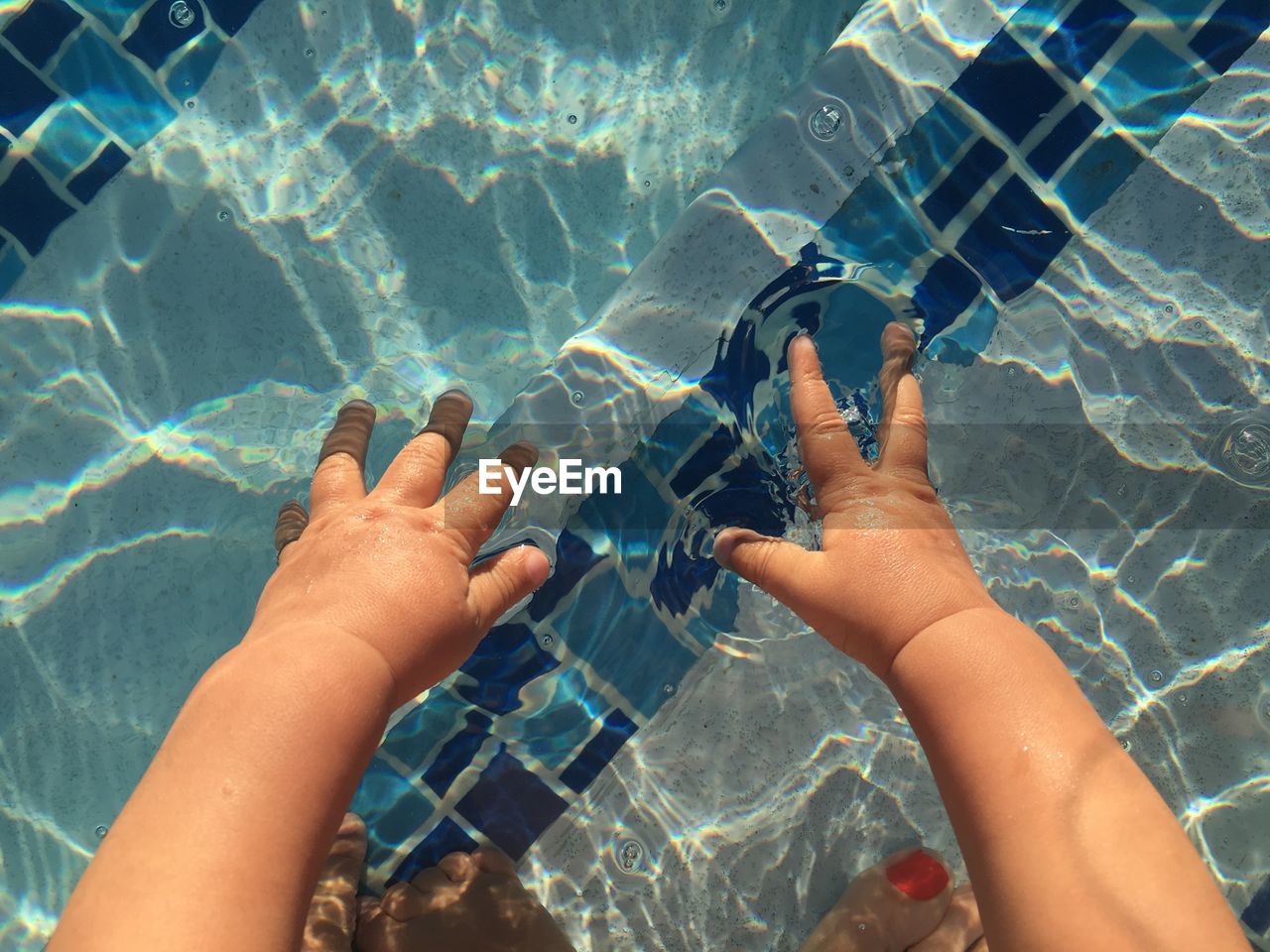 LOW SECTION OF PERSON SWIMMING IN SEA