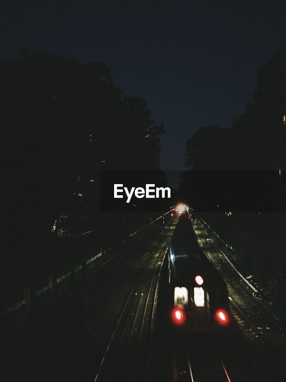 High angle view of train on railroad track at night