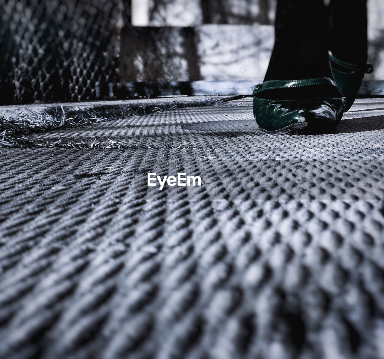 CLOSE-UP LOW SECTION OF MAN WEARING SHOES OUTDOORS