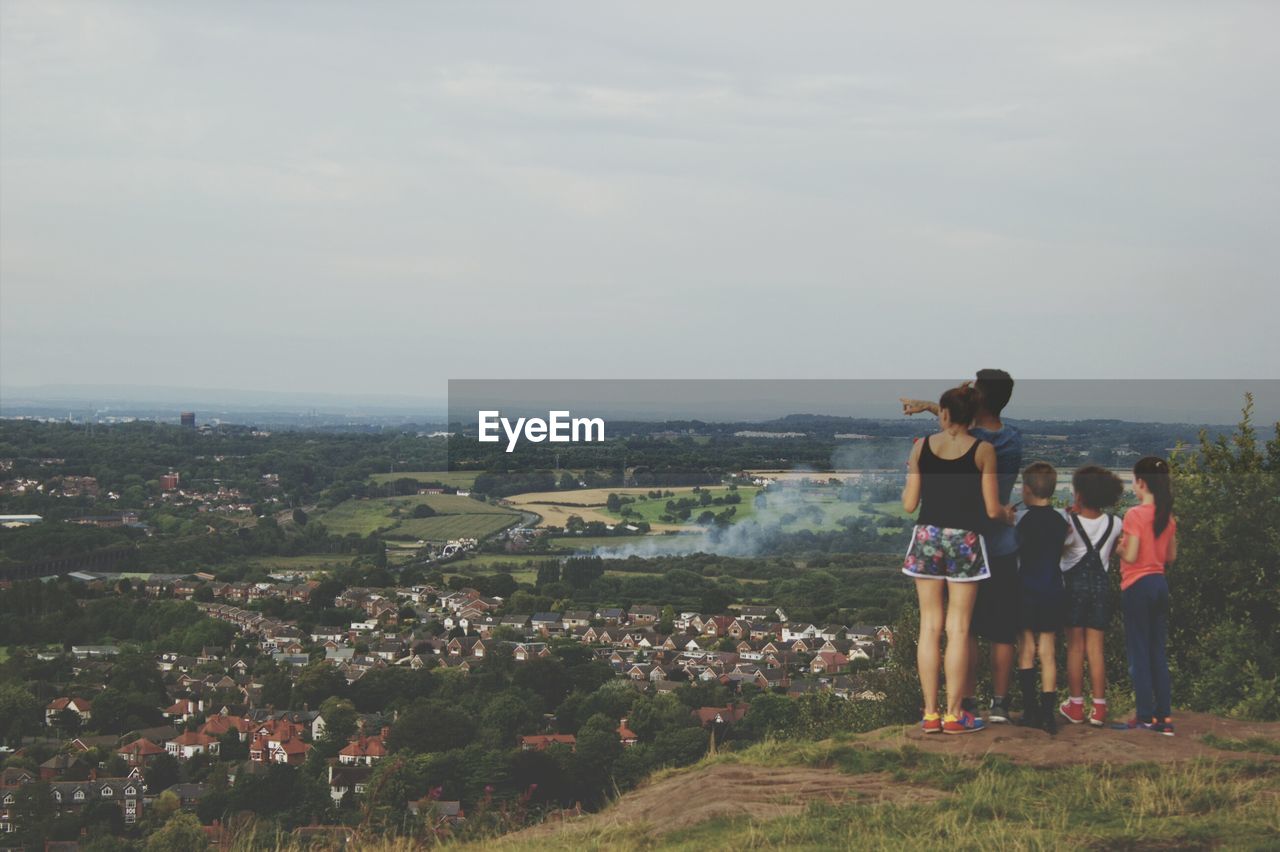 WOMAN LOOKING AT CITYSCAPE