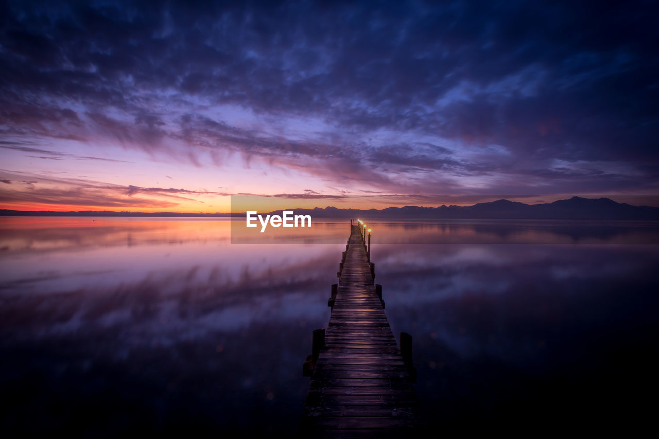 Scenic view of lake against sky during sunset