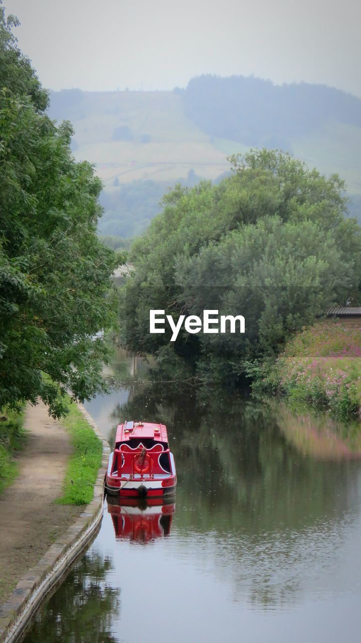 Boat on river against sky