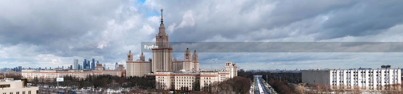 Wide angle panorama of spring campus of famous university in moscow under dramatic cloudy sky