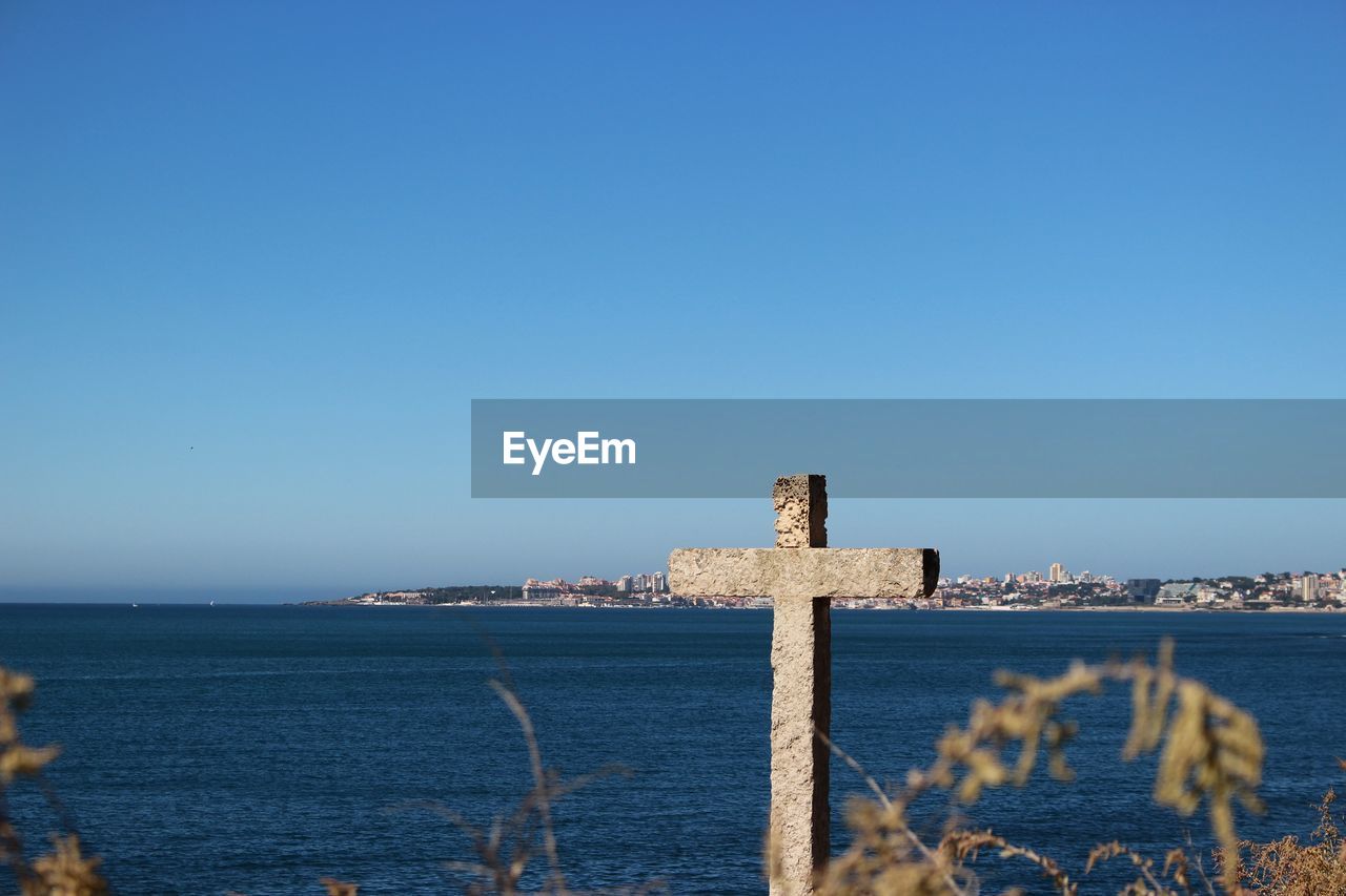 Scenic view of sea against clear blue sky