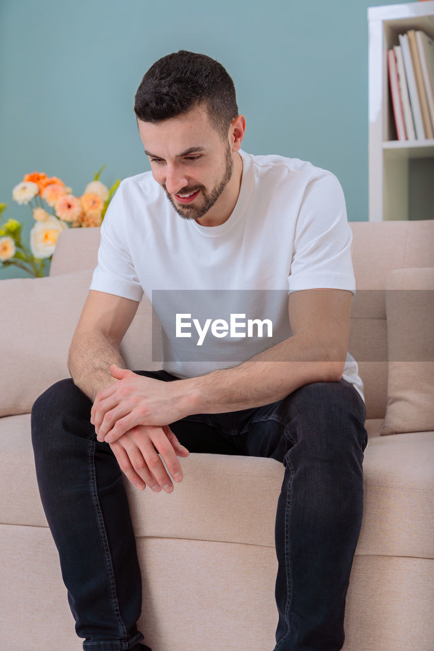 young man sitting on sofa