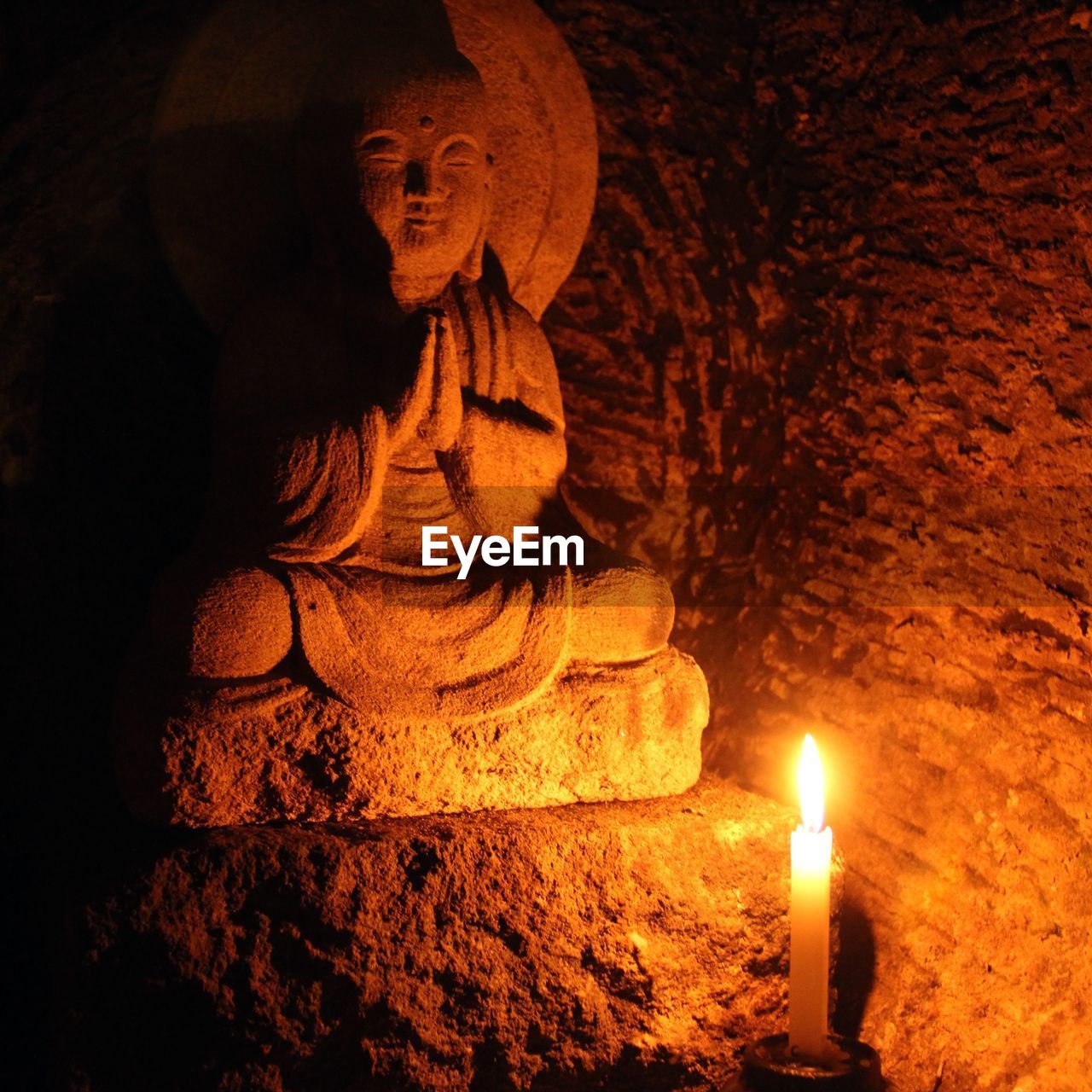 CLOSE-UP OF STATUE AGAINST ILLUMINATED LIGHT