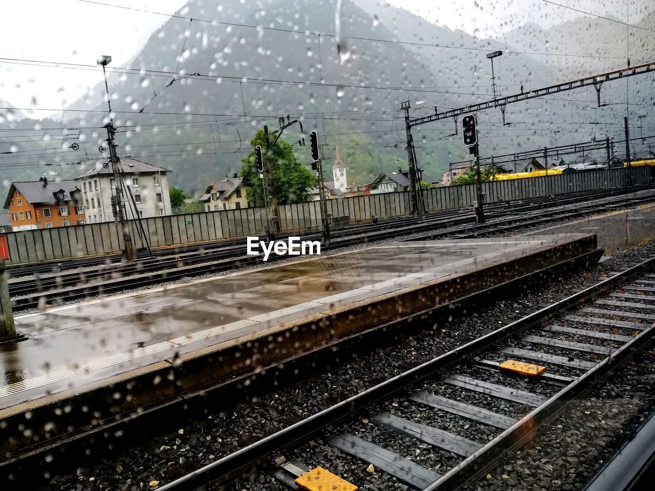 Railroad tracks in city against sky