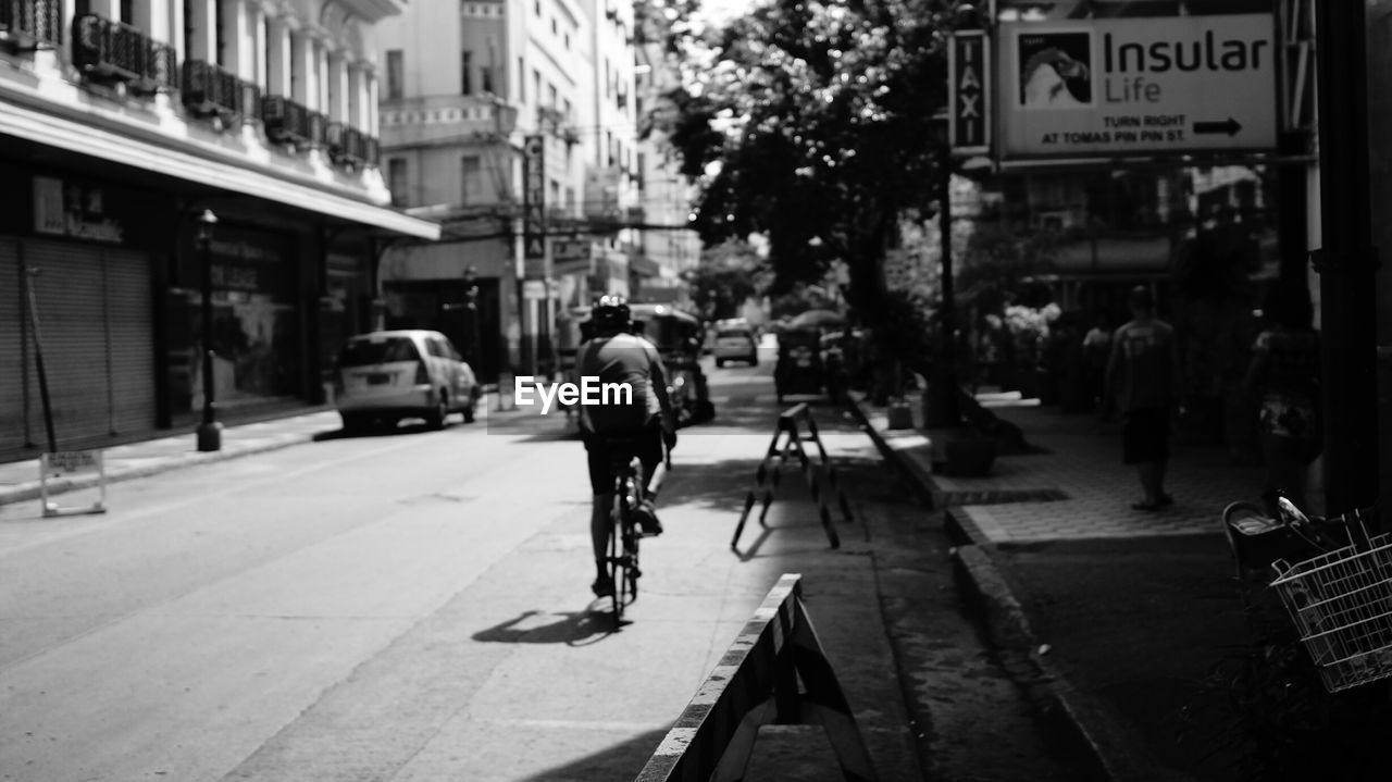 Rear view of man on bicycle