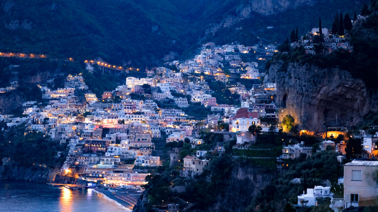 High angle view of illuminated buildings in city at night