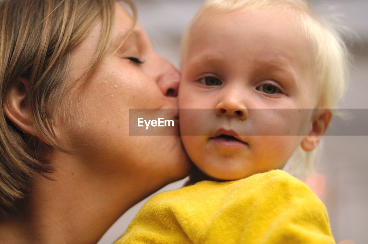 Close-up of mother kissing son