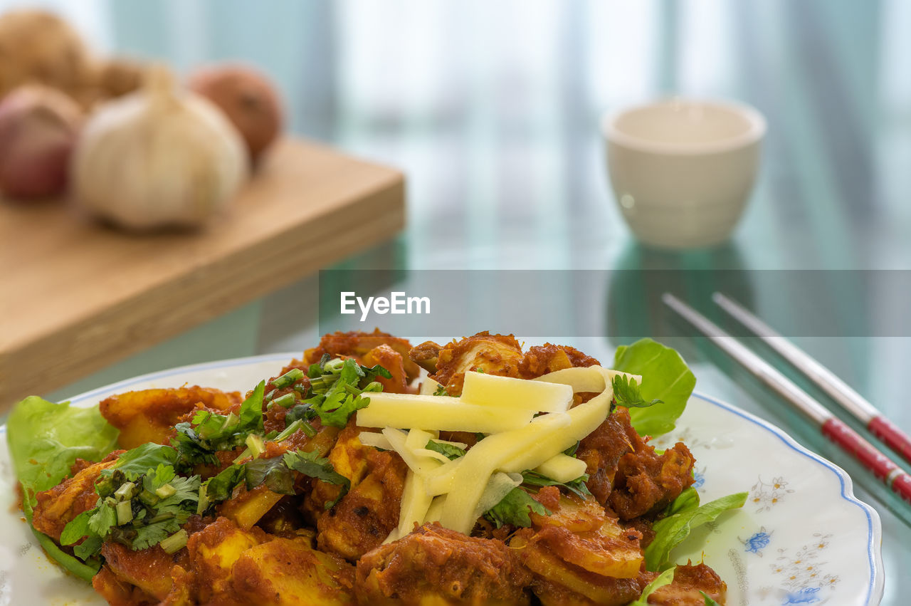 Golden brown crunchy turmeric fried chicken, on a white plate, is a favorite in malaysia