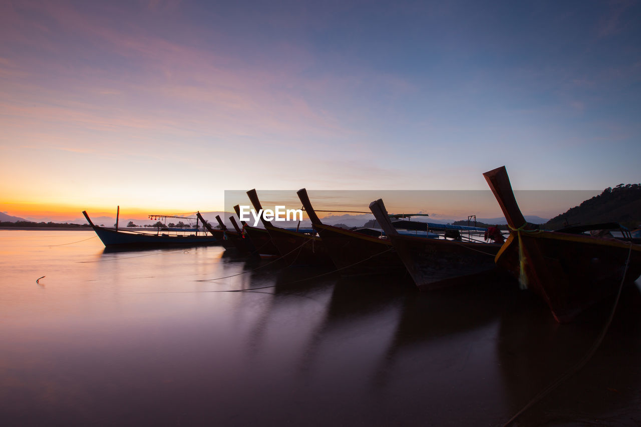 high angle view of boat on lake against sky during sunset