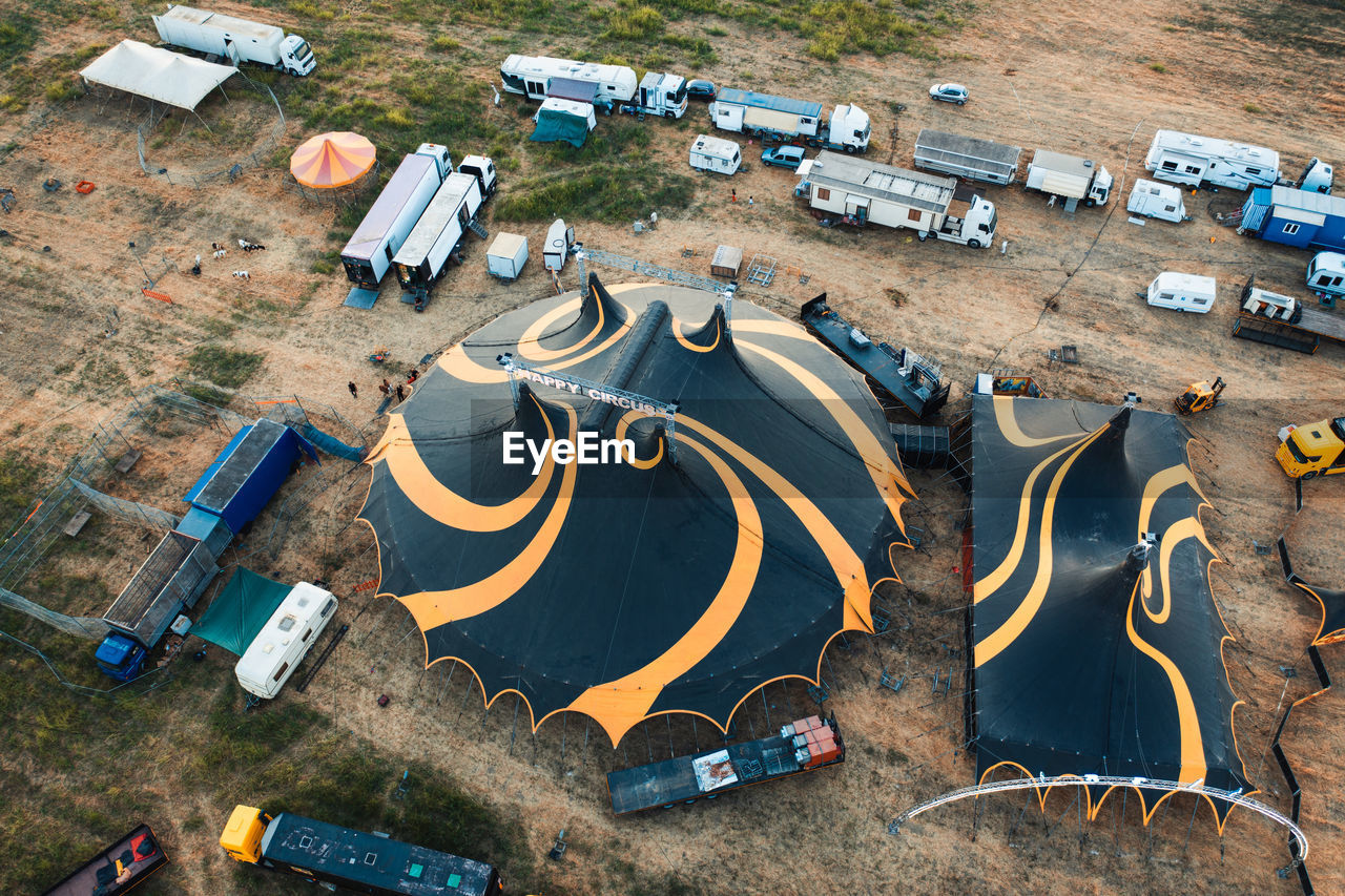 The yellow and black circus tent with animals and jugglers