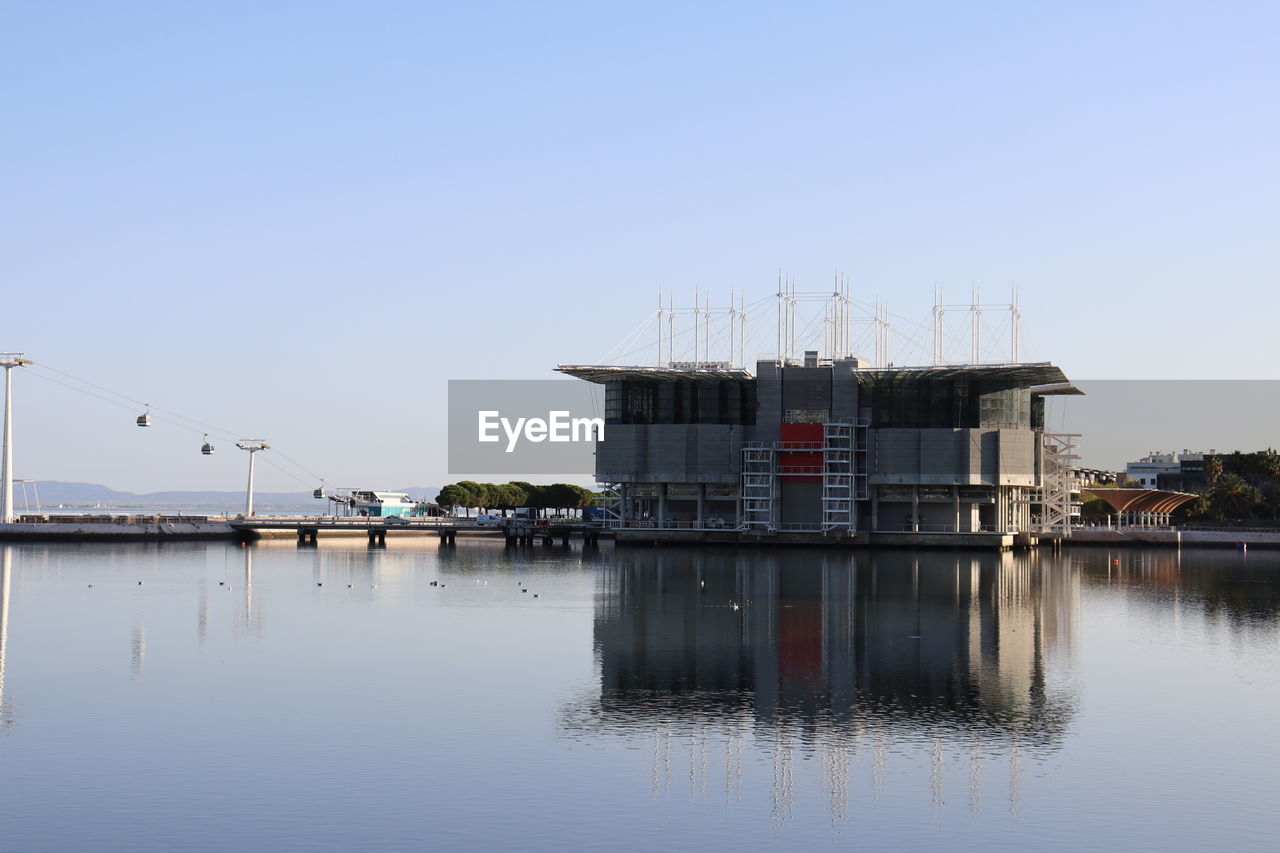 Building by sea against clear sky