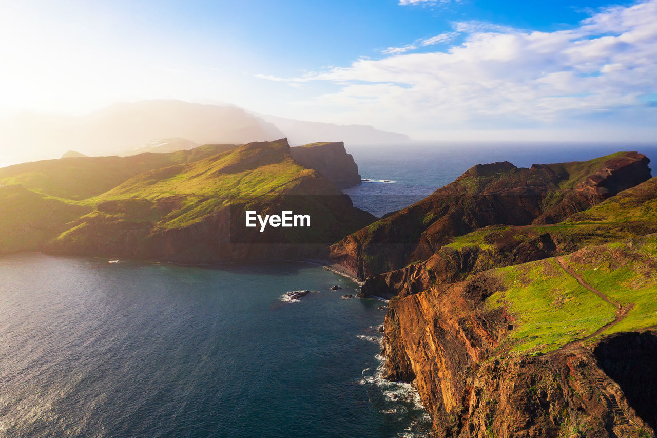 panoramic view of sea and mountains against sky