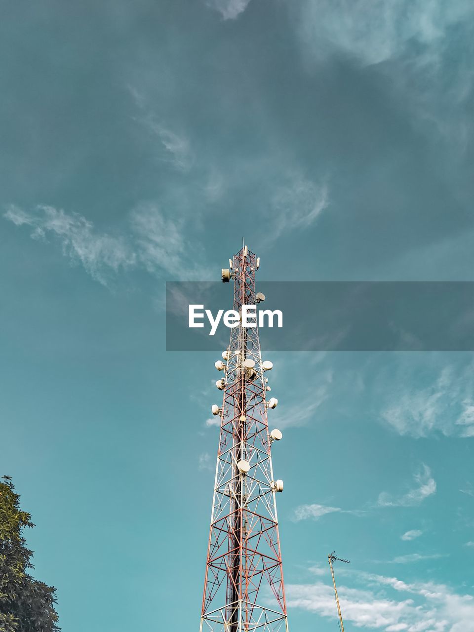 Low angle view of communications tower against sky