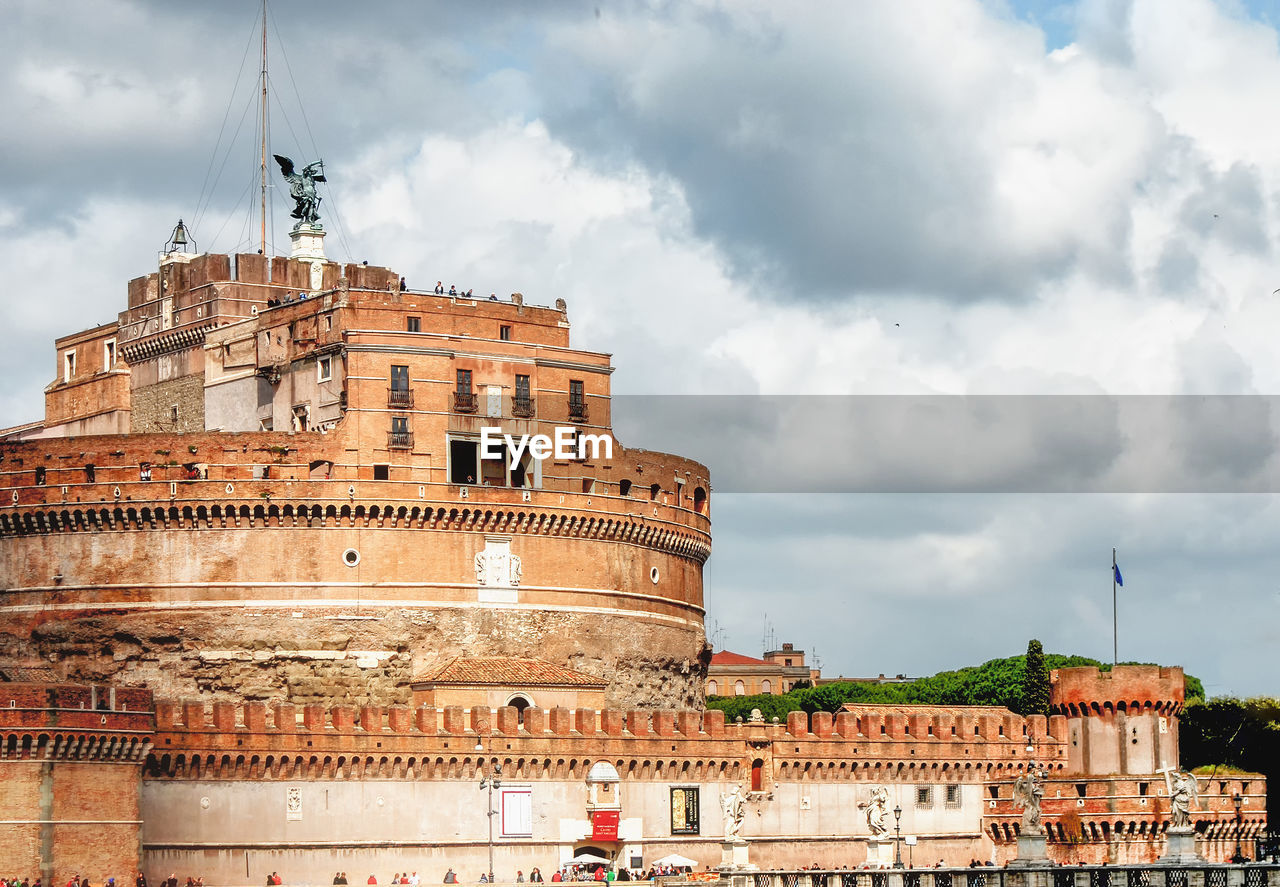 Low angle view of historical building against cloudy sky