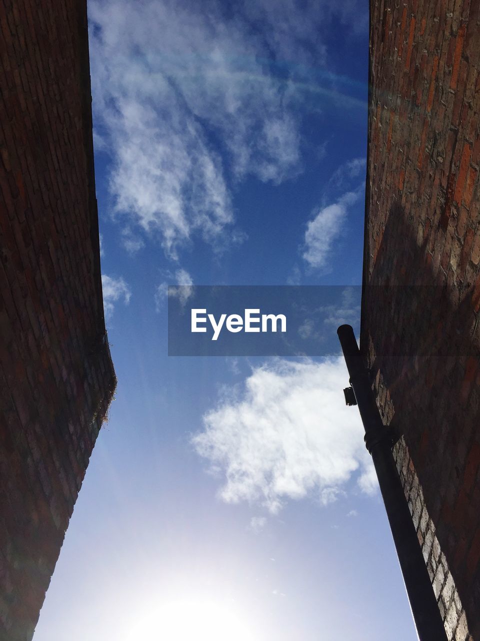 LOW ANGLE VIEW OF BUILT STRUCTURES AGAINST BLUE SKY