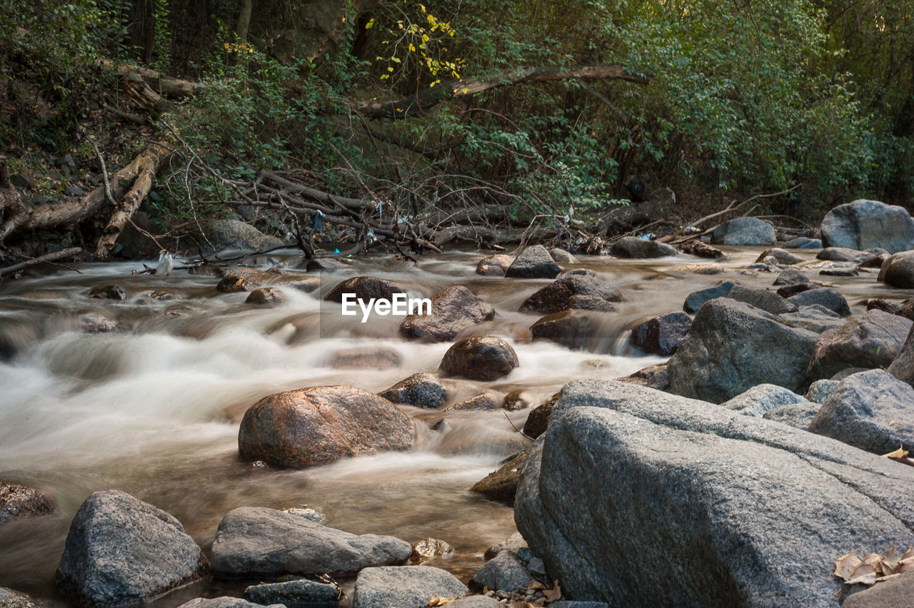 VIEW OF STREAM FLOWING THROUGH ROCKS