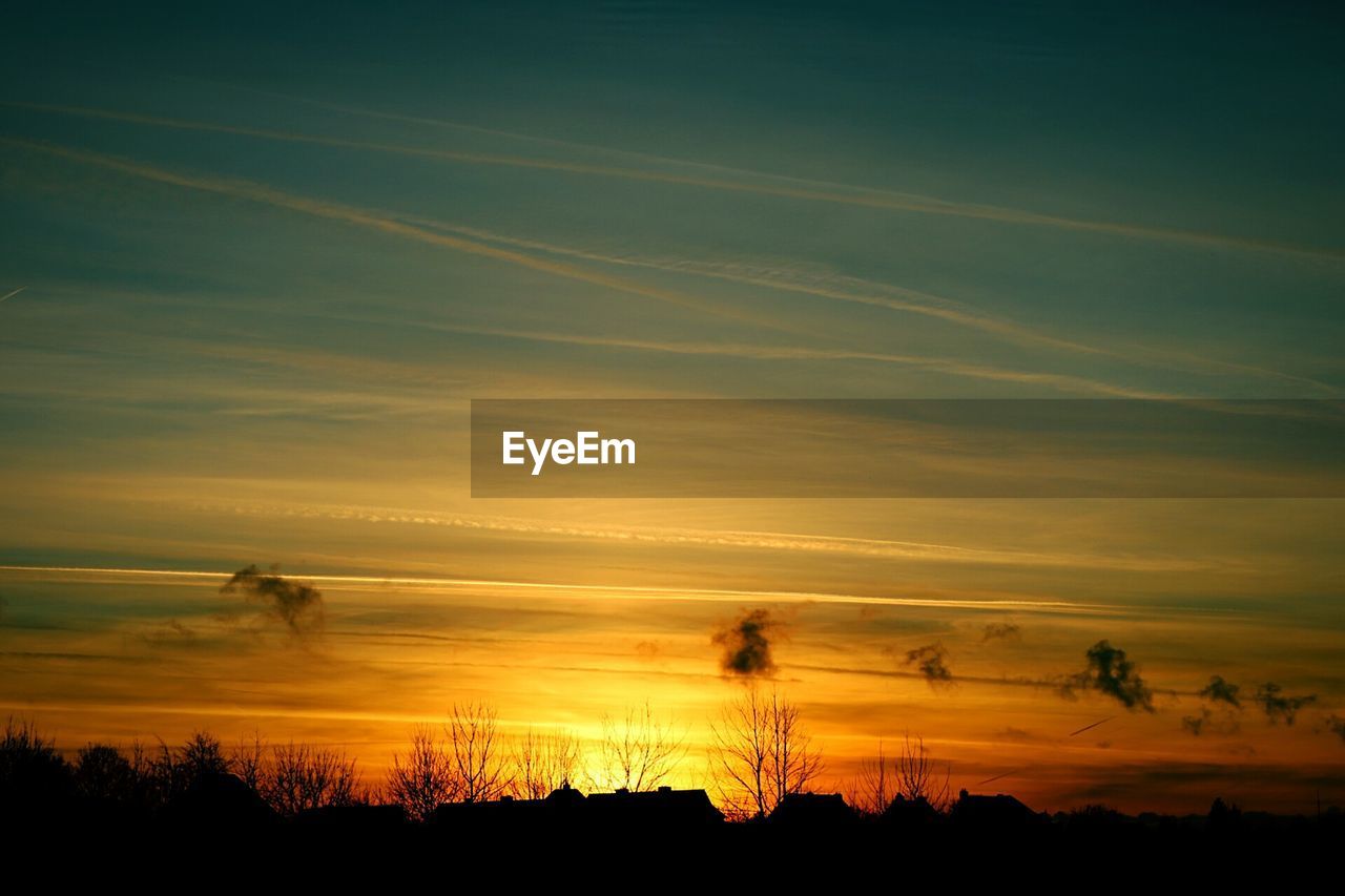 Silhouette landscape against sky at sunset