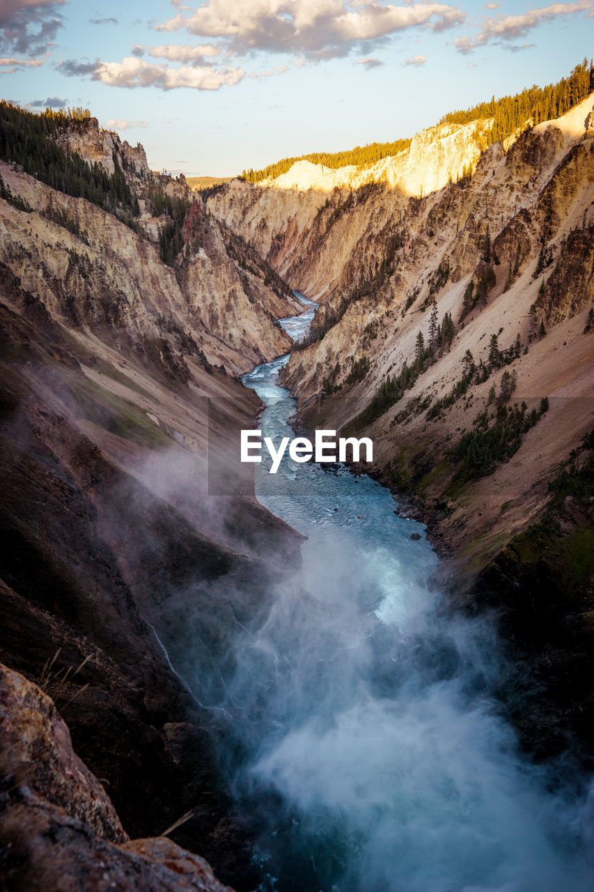 Scenic view of water amidst mountain against sky