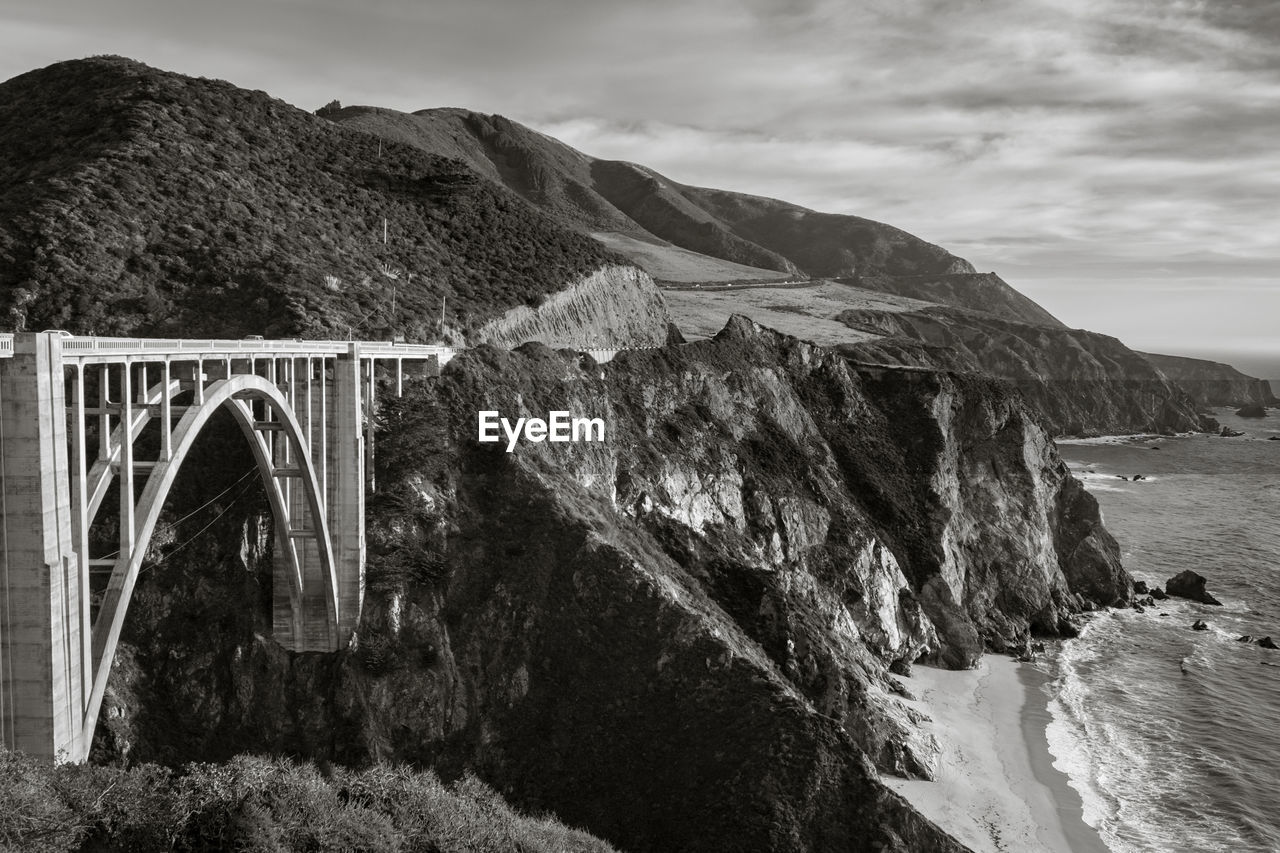 Arch bridge over sea against sky