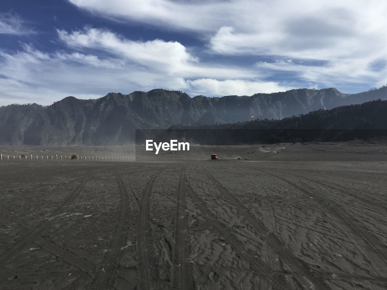 Scenic view of land and mountains against sky