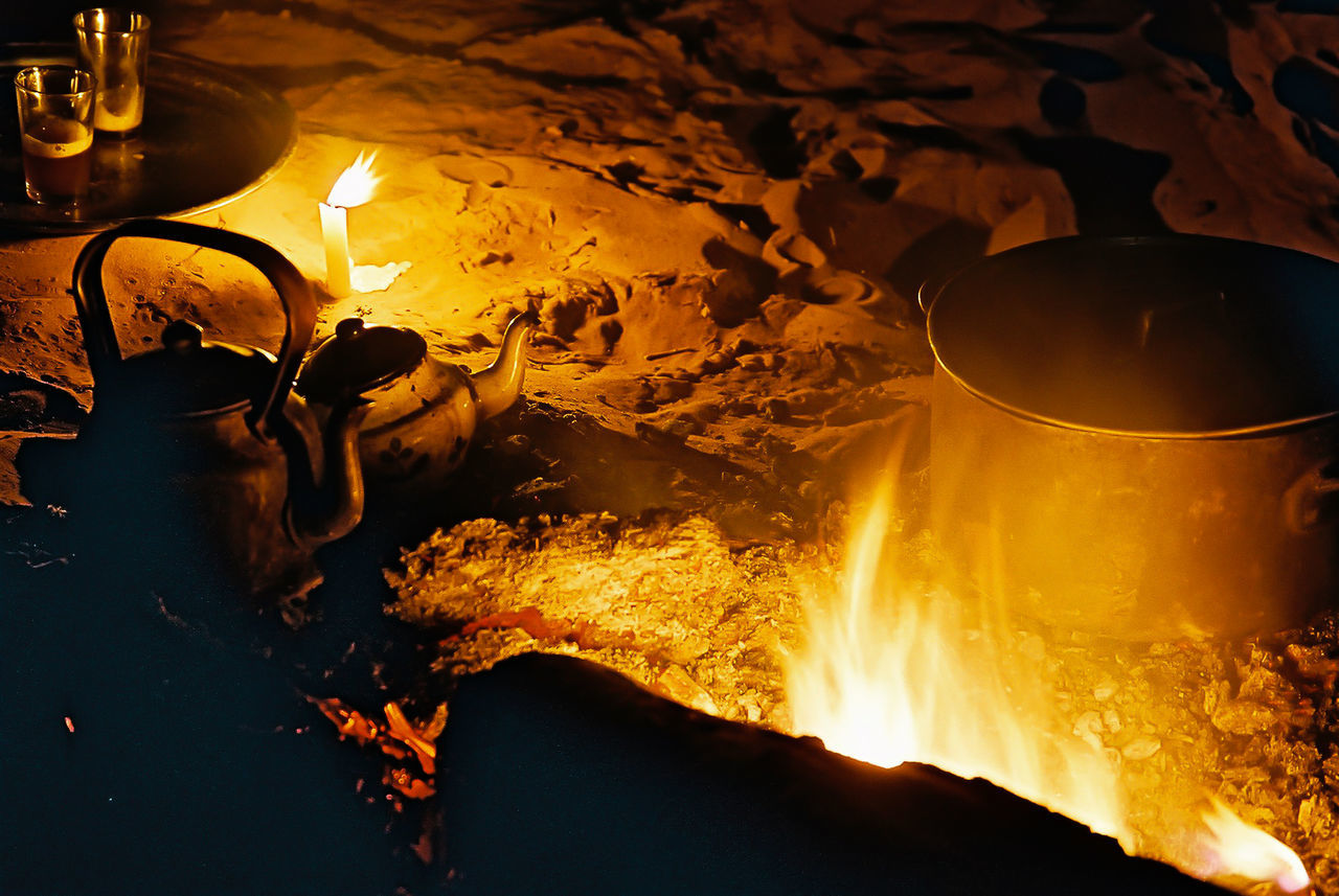 High angle view of food and drink begin prepared on fire