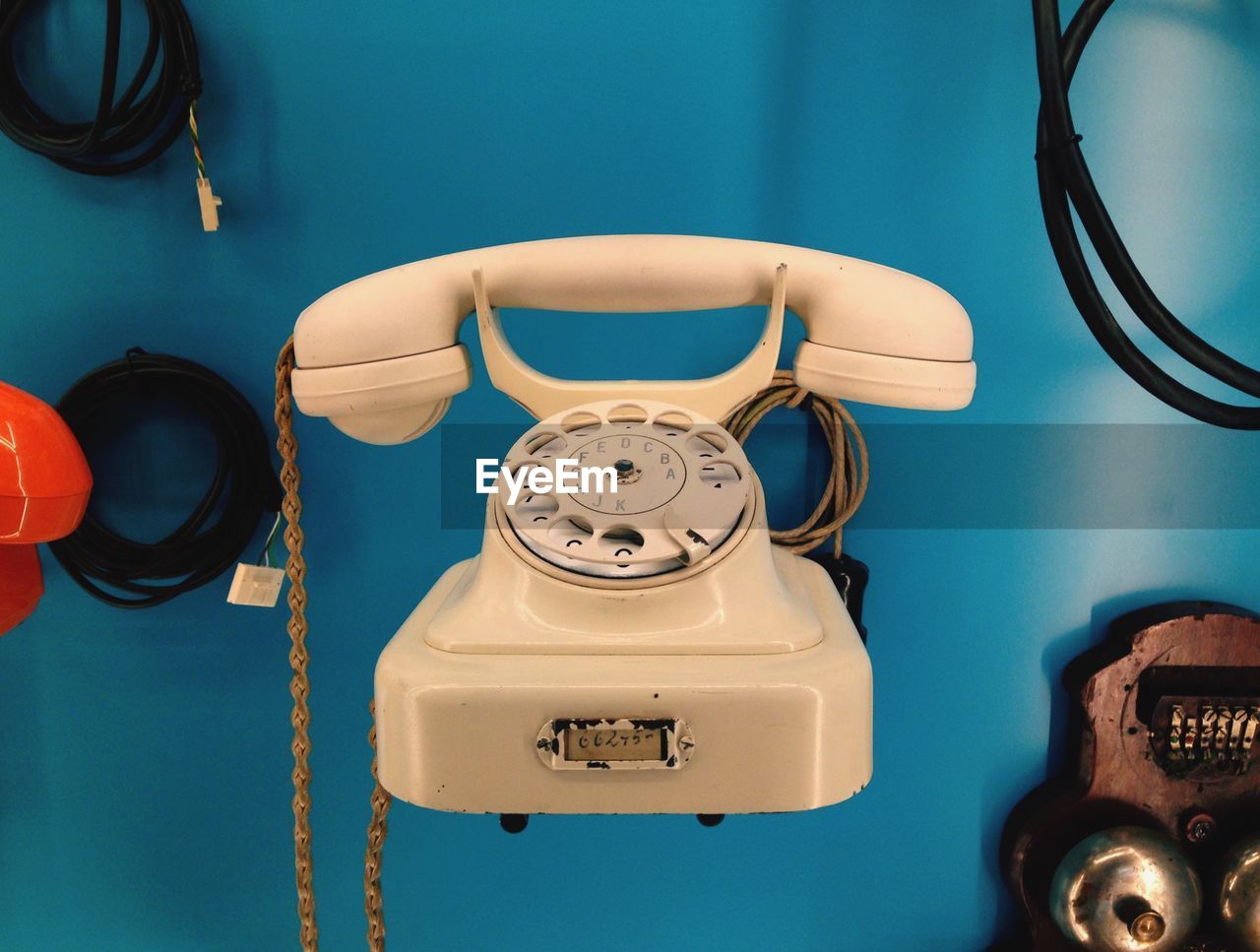 Antique telephone against blue wall